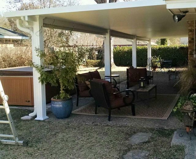 Covered patio with outdoor furniture and a ceiling fan