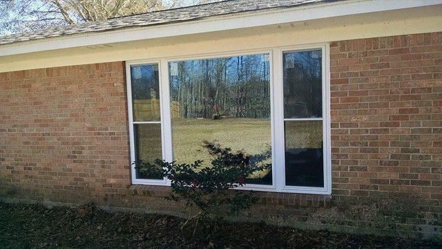 New picture window on a brick home